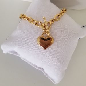 Gold fashion bracelet with heart charm.
